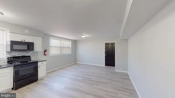 a kitchen with granite countertop a stove and a refrigerator