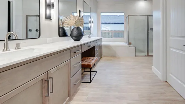 a bathroom with a double vanity sink a mirror and a shower
