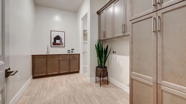 a view of a hallway with closet and a window