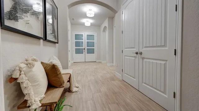 a view of a bedroom with furniture and wooden floor
