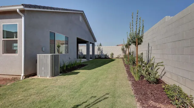 a front view of a house with a yard and potted plants