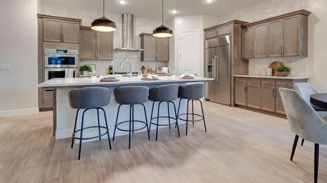 a kitchen with stainless steel appliances kitchen island wooden floors and view living room