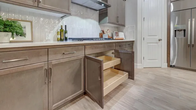 a kitchen with cabinets and wooden floor