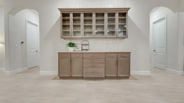 an empty room with cabinet with mirror