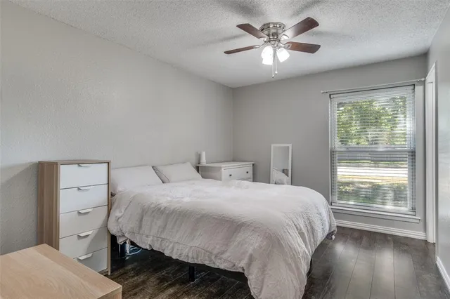 a bedroom with a bed and a ceiling fan
