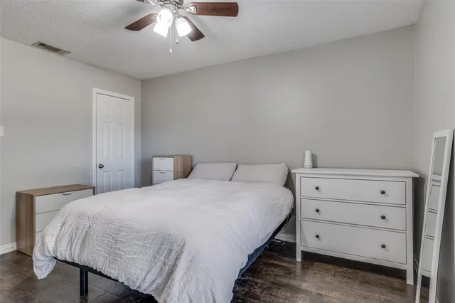a bedroom with a bed and a ceiling fan