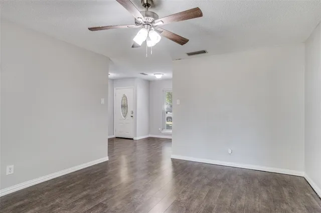 a view of an empty room with a fan