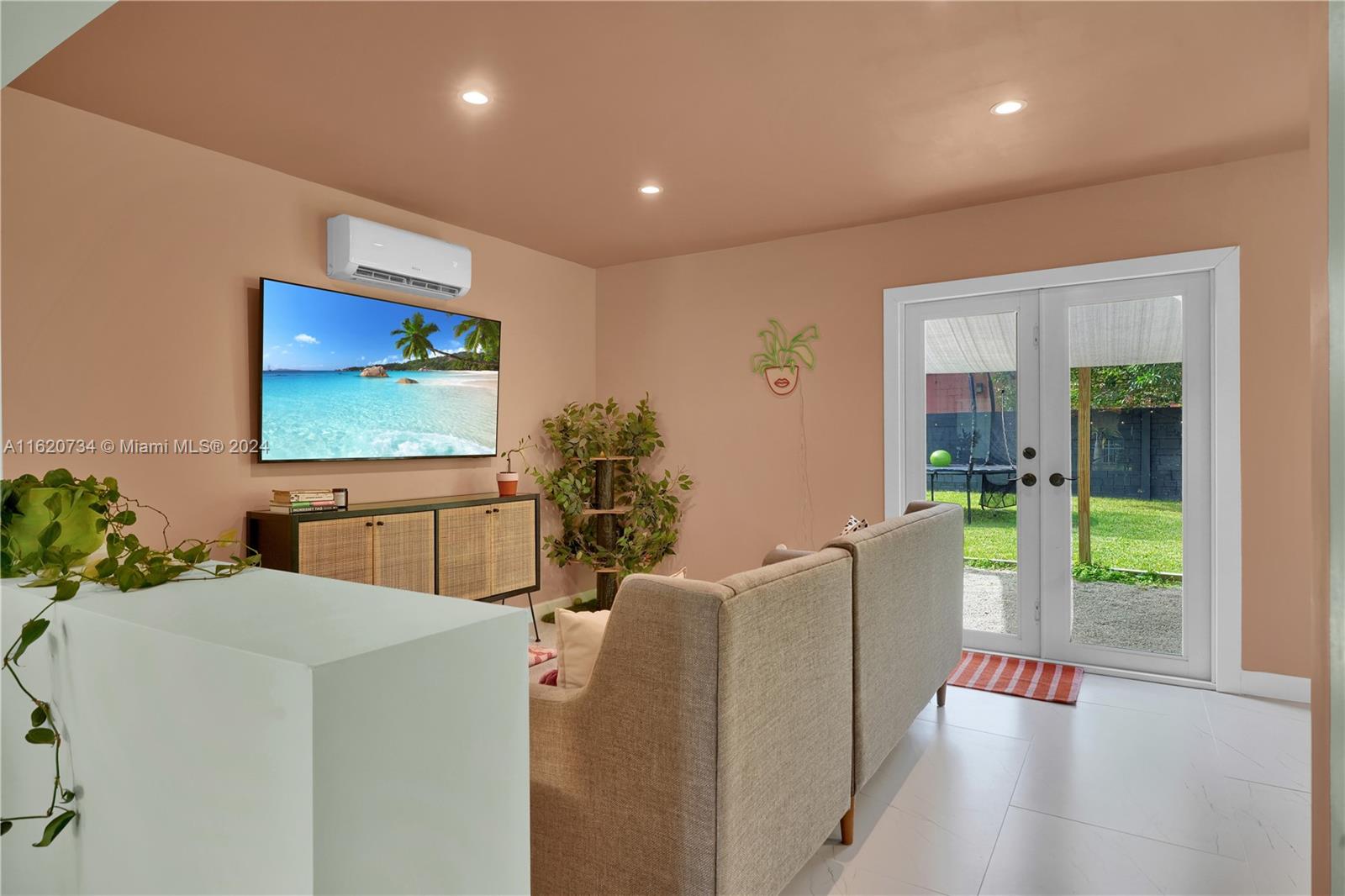 6411 Southwest 41st Street Miami, FL 33155 - Photo 12 of 17 a living room with furniture and a flat screen tv