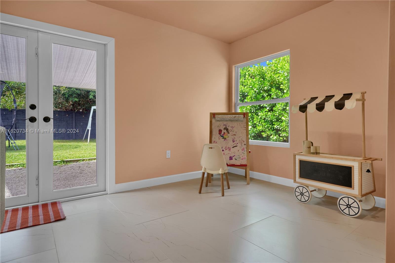 6411 Southwest 41st Street Miami, FL 33155 - Photo 13 of 17 a living room with furniture and a flat screen tv