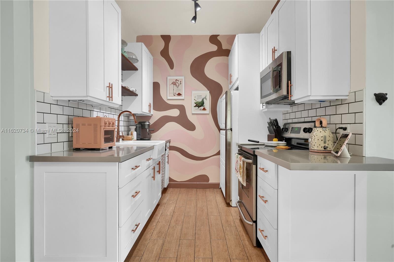 6411 Southwest 41st Street Miami, FL 33155 - Photo 3 of 17 a kitchen with stainless steel appliances a sink and a stove