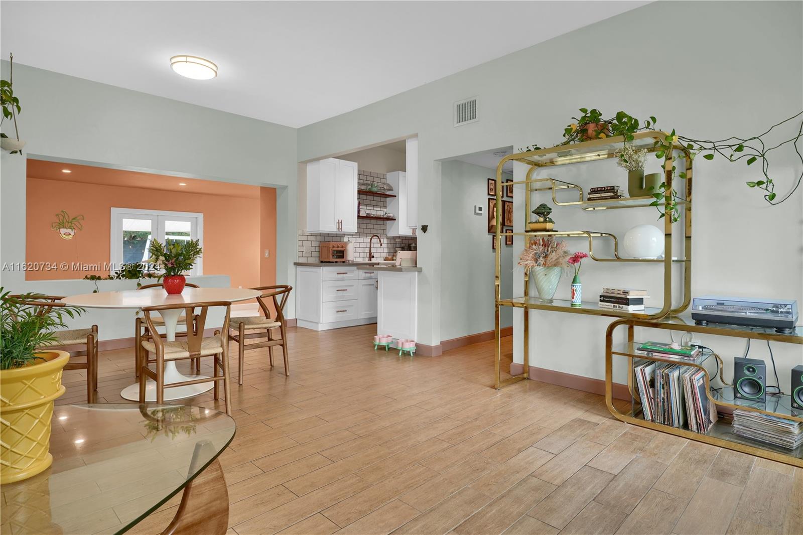 6411 Southwest 41st Street Miami, FL 33155 - Photo 5 of 17 a view of a dining room and livingroom with lots of furniture and wooden floor