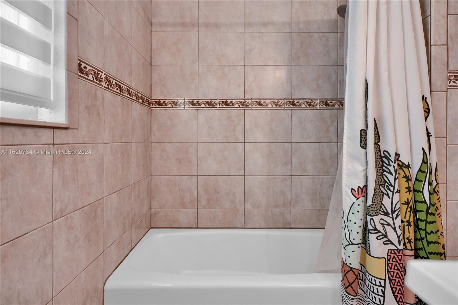 6411 Southwest 41st Street Miami, FL 33155 - Photo 9 of 17 a bathroom with a bathtub and shower