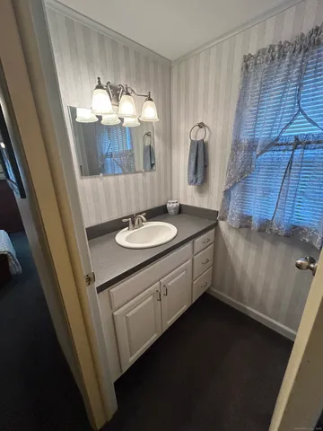 a bathroom with a sink a vanity and mirror