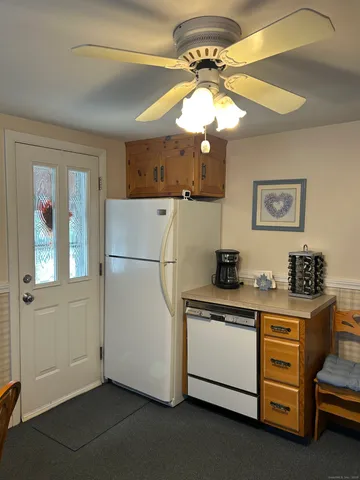 a kitchen with stainless steel appliances granite countertop a stove a refrigerator and a chandelier