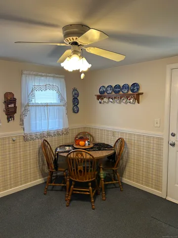 a view of a workspace with furniture and a chandelier