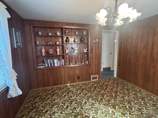 a bedroom with a large bed and wooden floor