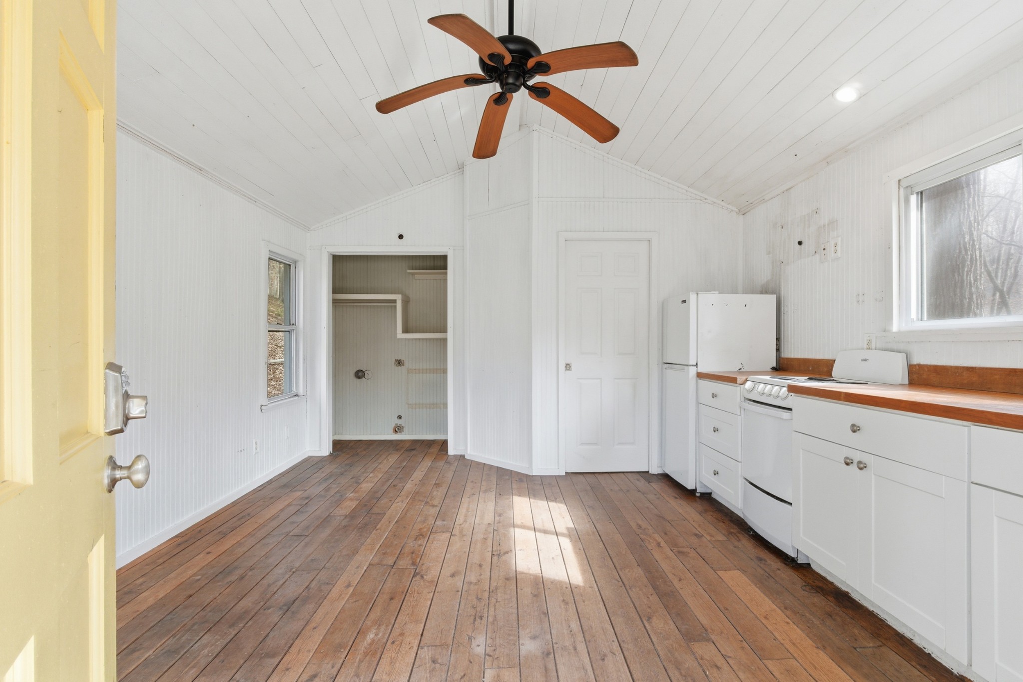 3972 Skelley Road Santa Fe, TN 38482 - Photo 19 of 47 a kitchen with wooden floors and white cabinets