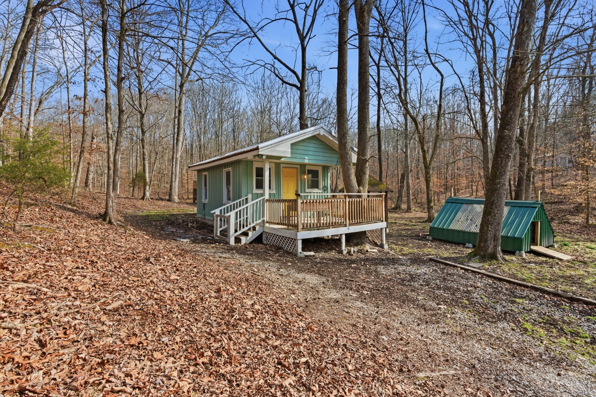 3972 Skelley Road Santa Fe, TN 38482 - Photo 2 of 47 a blue bench sitting in front of a house
