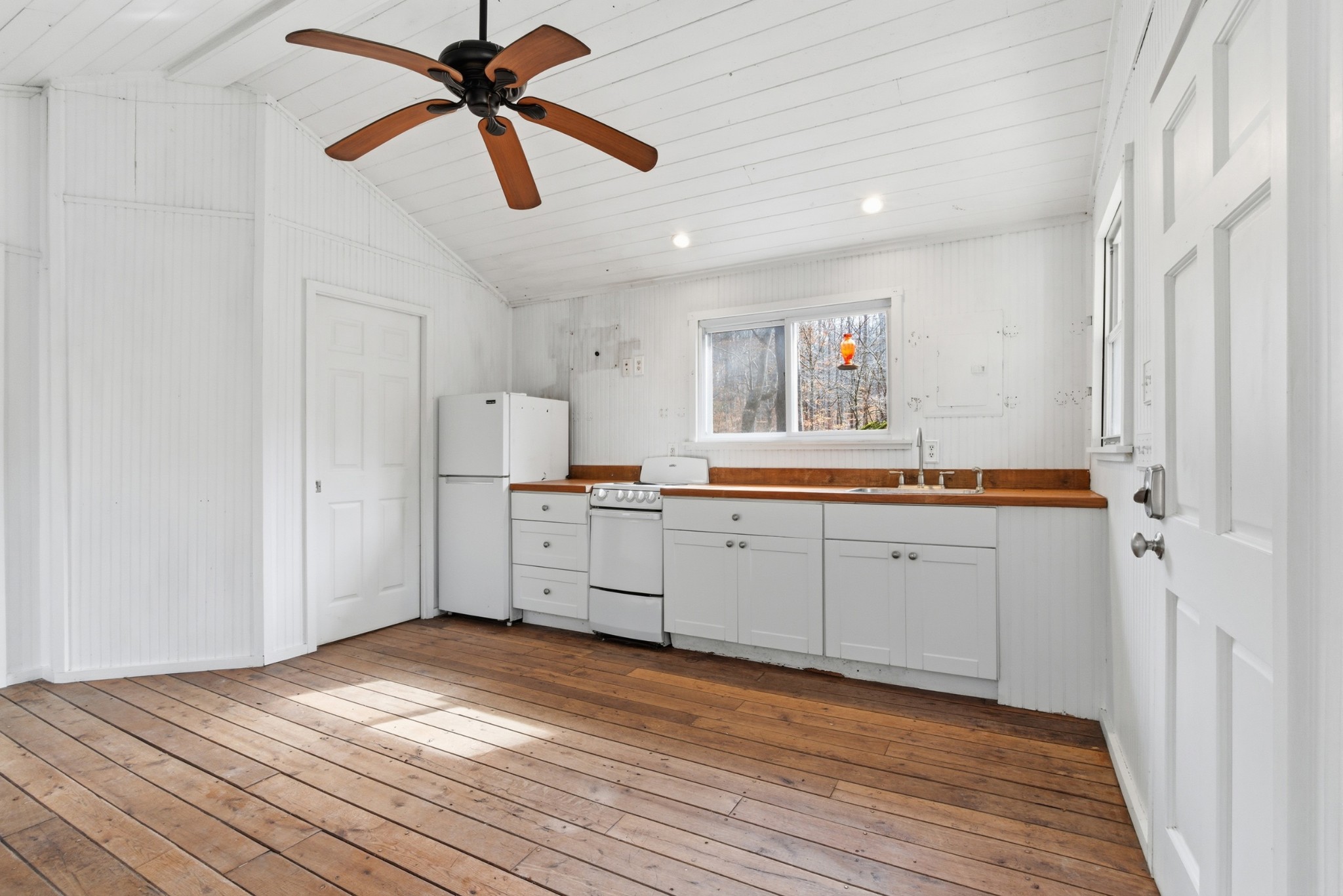 3972 Skelley Road Santa Fe, TN 38482 - Photo 21 of 47 a kitchen with a refrigerator window and white cabinets