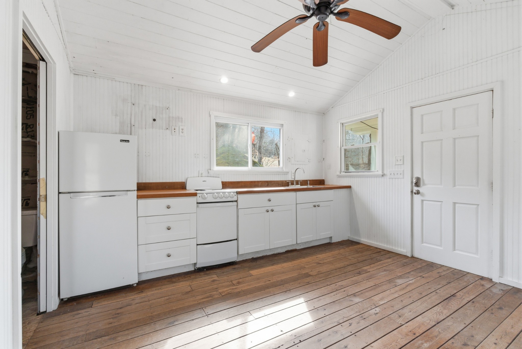 3972 Skelley Road Santa Fe, TN 38482 - Photo 23 of 47 a kitchen with white cabinets and white appliances