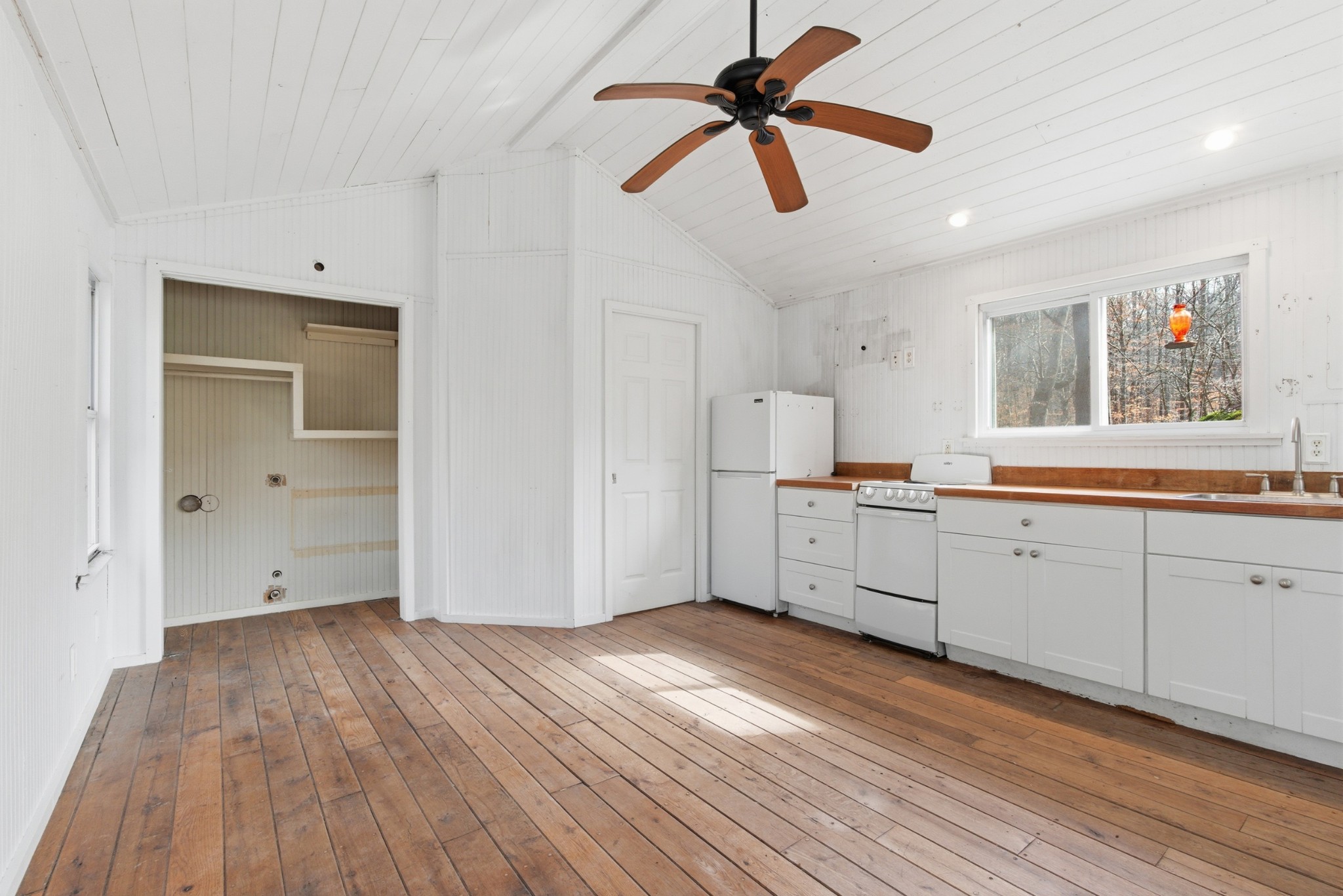 3972 Skelley Road Santa Fe, TN 38482 - Photo 25 of 47 a kitchen with white cabinets and wooden floor