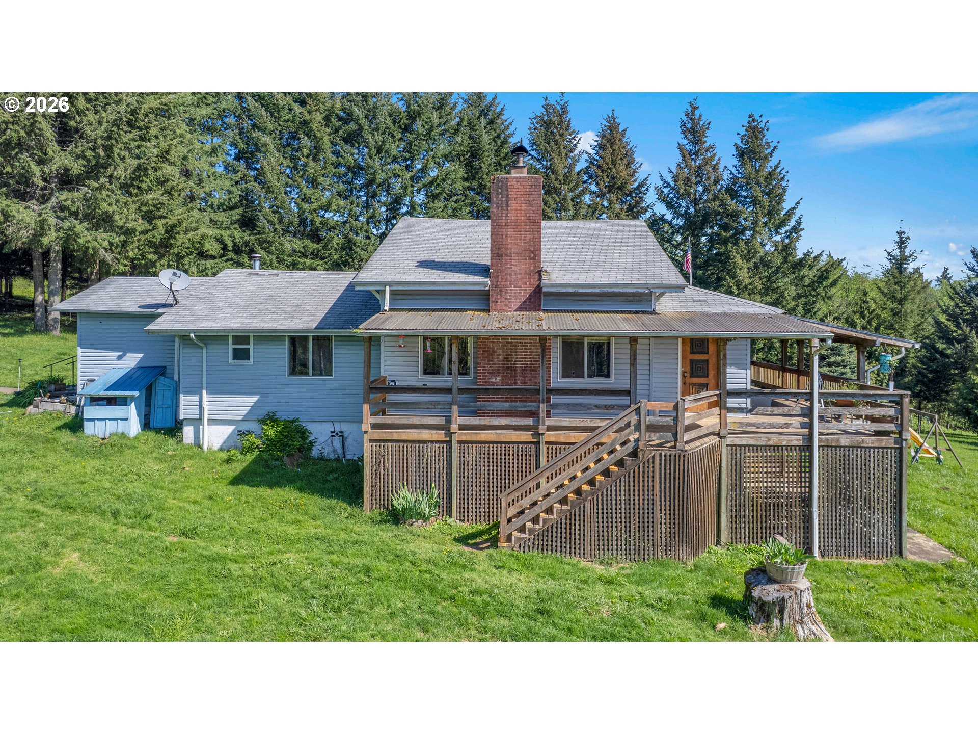 70896 Neer City Road Rainier, OR 97048 - Photo 1 of 46 a black and white house in front of a big yard with large trees