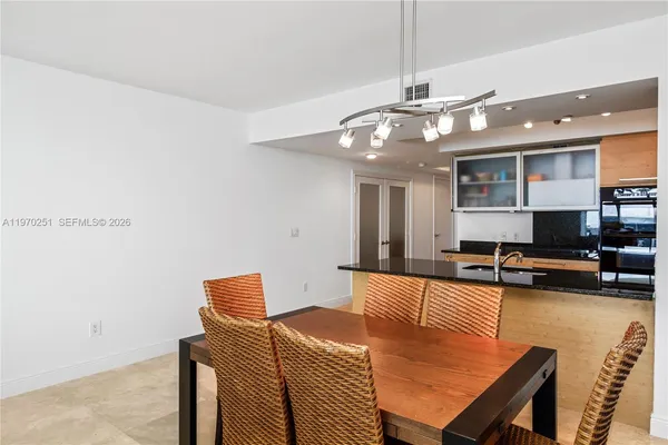 a living room with furniture and kitchen view