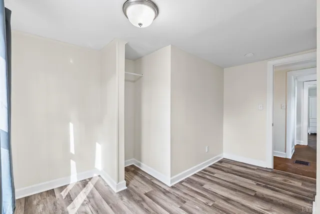 a view of bedroom with wooden floor
