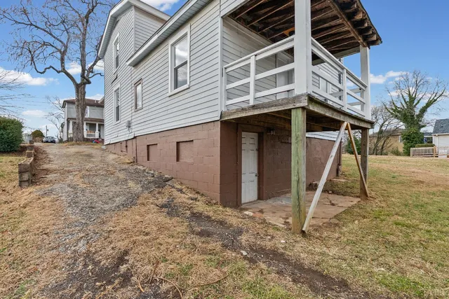 a view of a house with a wooden deck