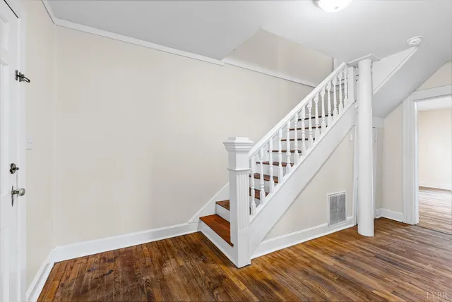 a view of entryway and hall with wooden floor