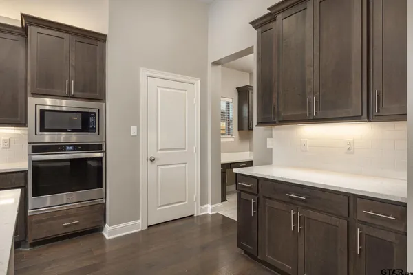 a kitchen with granite countertop wooden cabinets and stainless steel appliances
