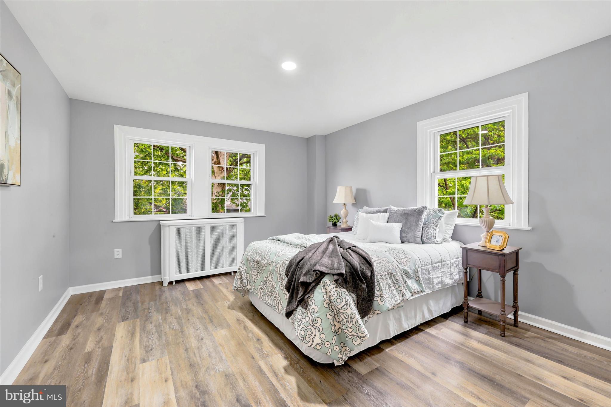 7208 Hilltop Road Upper Darby, PA 19082 - Photo 15 of 28 a bedroom with a bed two lamps and a large window with outer view