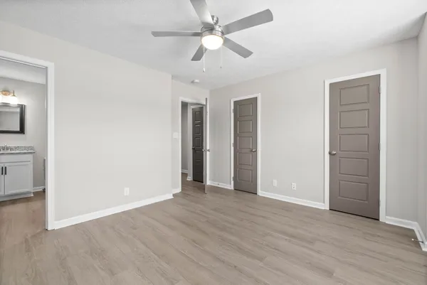 a view of an empty room with wooden floor