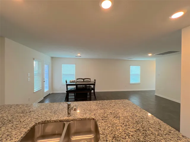 a kitchen with granite countertop a stove and a sink