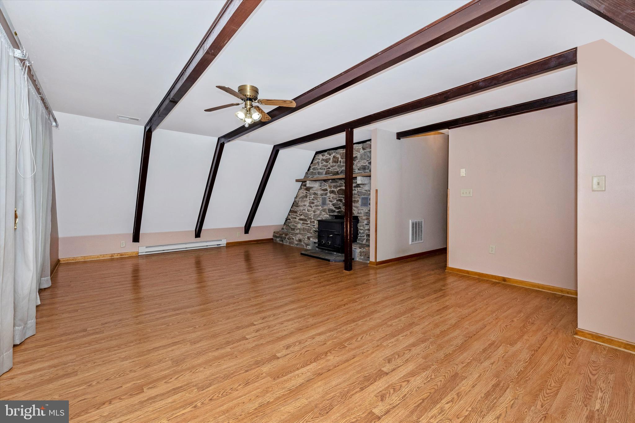 6119 Quinn Road Frederick, MD 21701 - Photo 3 of 37 Living Room with Exposed Beams and Wood Stove
