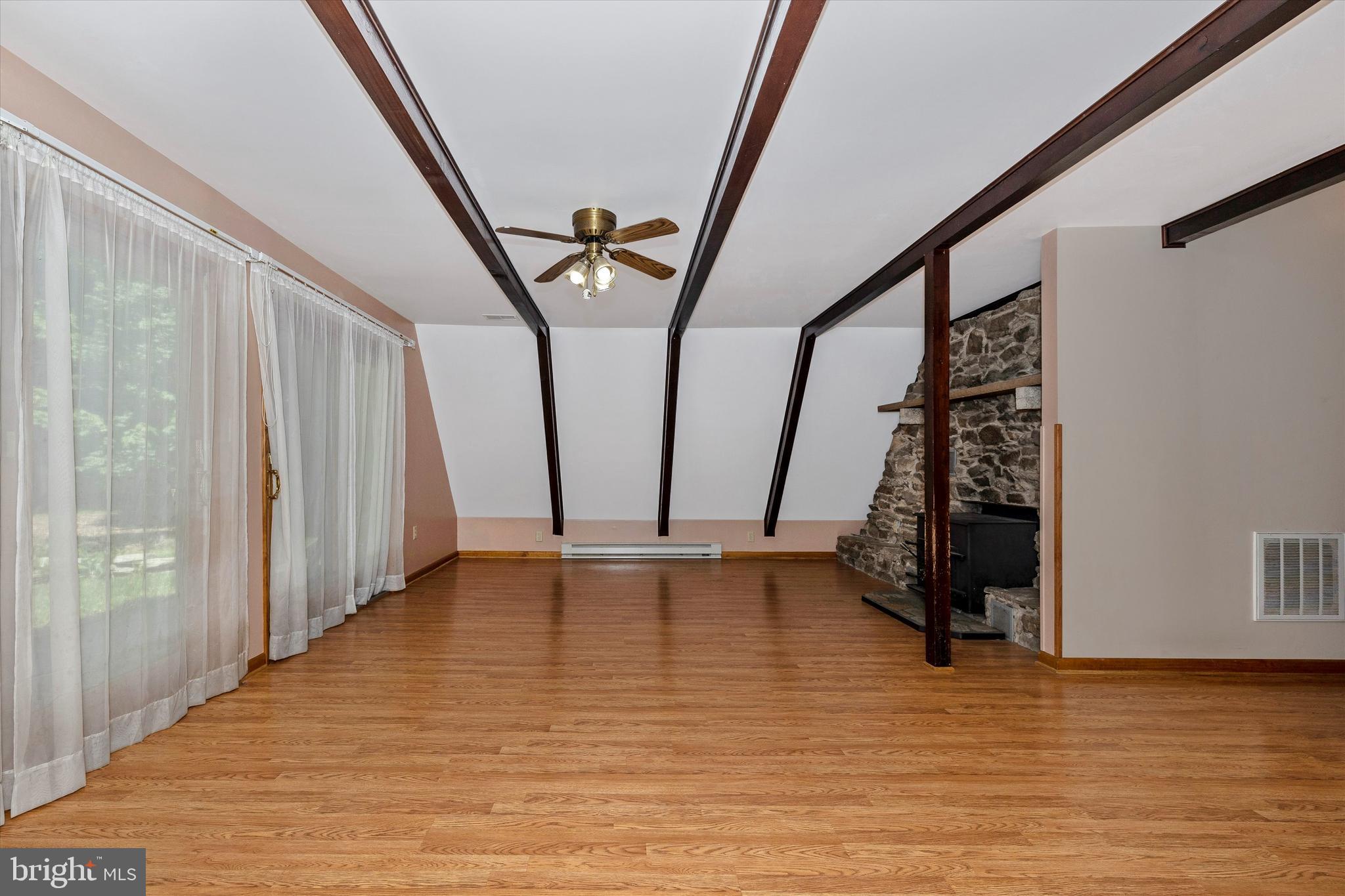 6119 Quinn Road Frederick, MD 21701 - Photo 4 of 37 Living Room with Exposed Beams and Wood Stove