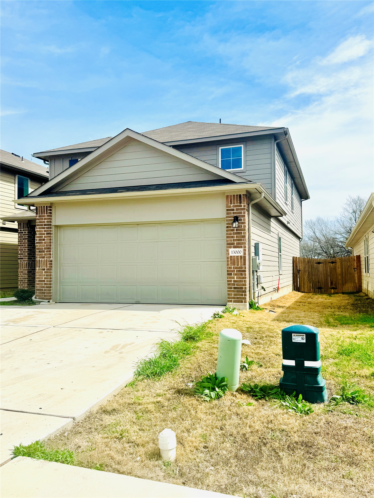 Traditional-style home featuring concrete driveway, brick siding, and a garage