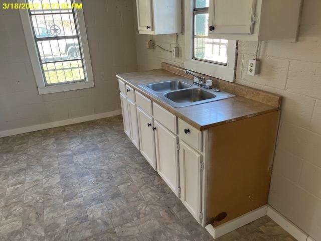 9583 South 3rd St Road Waco, TX 76706 - Photo 5 of 12 an empty room with windows and chandelier