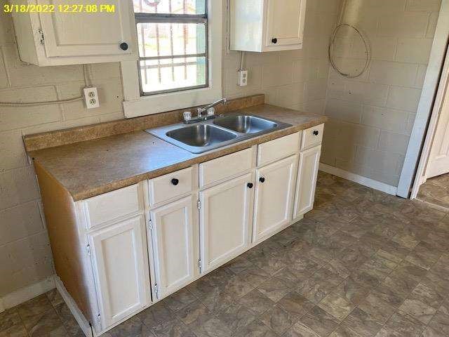 9583 South 3rd St Road Waco, TX 76706 - Photo 6 of 12 a kitchen with white cabinets a sink and dishwasher