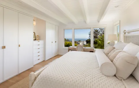a bedroom with a large bed and furniture