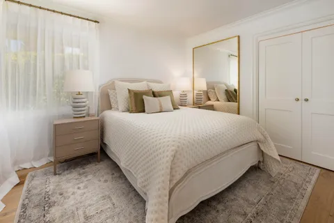 a bed room with a bed and a night stand