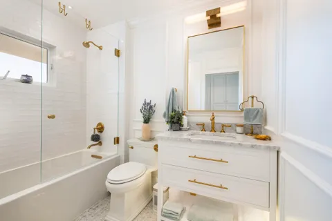 a bathroom with a sink a toilet and a mirror