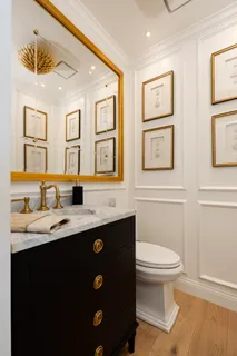 a bathroom with double sink and a toilet