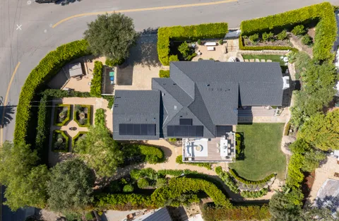 an aerial view of a house with a garden and plants