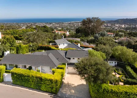 an aerial view of a house with a yard