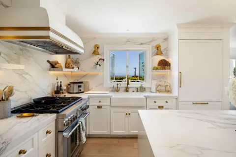 a kitchen with stainless steel appliances a stove a sink and a refrigerator
