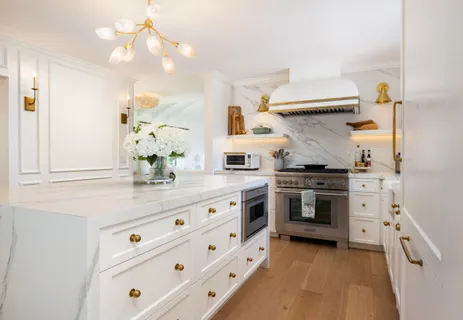 a kitchen with granite countertop white cabinets and stainless steel appliances