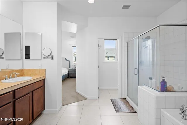 a bathroom with a tub sink and mirror