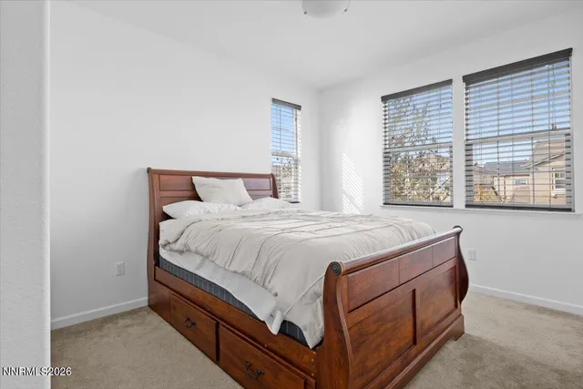 a bed sitting in a bedroom next to a window