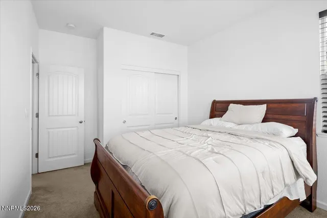 a bedroom with a bed and a mirror